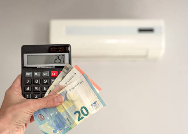 mano con calculadora y billetes calculando precio de reparación de aire acondicionado